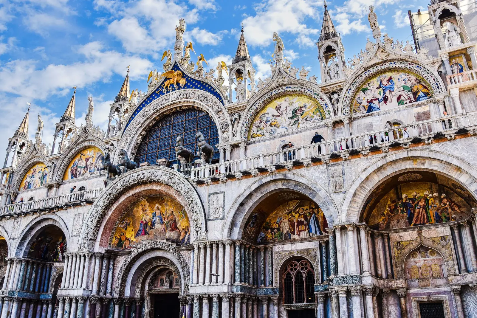 Close exterior view of St Mark’s Basilica’s ornate facade and arches in Venice.